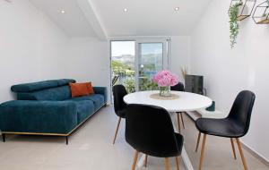 a living room with a blue couch and a table at MaMi in Korčula