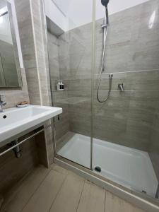 a bathroom with a shower and a sink and a tub at Elamar Rooms & Apartment in Gallipoli +42 photos