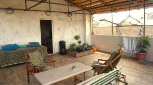 a living room with a table and chairs at Pospolita Guest House in Kutaisi