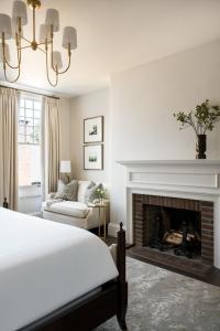 a bedroom with a bed and a fireplace at 86 State Circle - Luxury Boutique Hotel in Annapolis