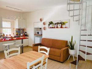 a kitchen and a living room with a couch and a table at L'Affaccio in Amantea