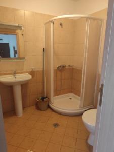 a bathroom with a shower and a toilet and a sink at Dima Popova Apartments in Tsarevo