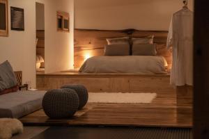 a bedroom with a bed with a wooden headboard at Bosco Antigua in Antigua Guatemala +33 photos