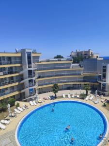 a large swimming pool in front of a hotel at Dima Popova Apartments in Tsarevo