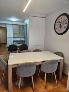 Una mesa y sillas en una habitación con un reloj en la pared. en Mareas Vivas, en Malpica de Bergantiños 8 fotos más