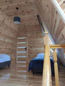 a bedroom with a bed and a staircase in a room at Szewilla in Szewnia +24 photos