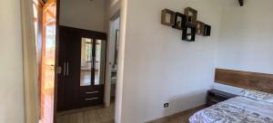 a bedroom with a bed with a wooden headboard and a mirror at Casa Santa Rosilla in Lamas