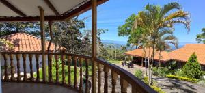 a balcony of a house with a palm tree at Casa Santa Rosilla in Lamas