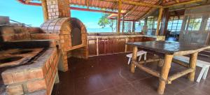a kitchen with a table and a brick oven at Casa Santa Rosilla in Lamas
