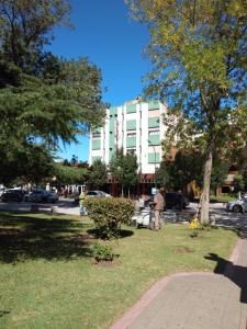 a man standing in a park in front of a building at Plaza hotel in Dolores