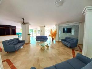 a living room with blue couches and a tv at APARTAMENTO RODADERO MAR In in Gaira