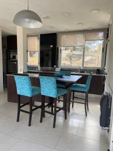 a kitchen with a wooden table and chairs at Casa Cabalango in Cavalango
