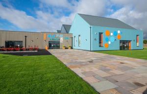 a building with a mural on the side of it at Adventure Van 6 berth St Osyth Beach Park in Saint Osyth
