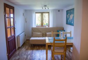 a living room with a table and a couch at Wild Wine House in Gdynia +17 photos