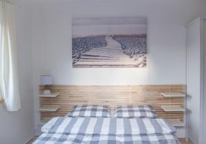a bedroom with a bed with a painting on the wall at Wild Wine House in Gdynia