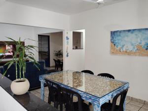 a dining room with a blue table and chairs at Casa 55 in Guarapari