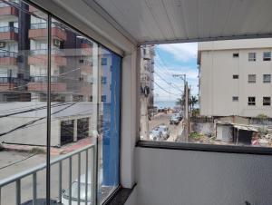 a balcony with a view of a city street at Casa 55 in Guarapari
