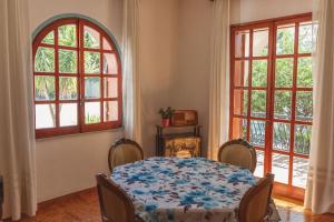 a dining room with a table and two windows at Villino TerrAmare in Reggio di Calabria