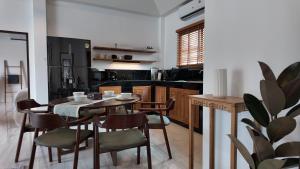 a kitchen and dining room with a table and chairs at ILKI 2BR Pool Villa in Ko Phangan