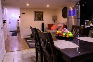 a kitchen and living room with a table and a refrigerator at Entire suite Queen BRM Big Window Prvt Entry Patio in Edmonton