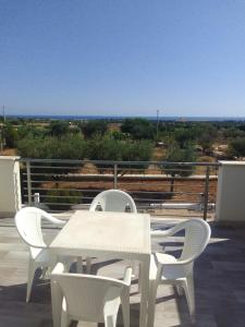 a white table and chairs sitting on a roof at Villa Chirilú in Polignano a Mare