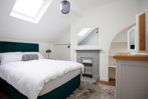 une chambre avec un lit et une cheminée dans l'établissement Raven Willow, à Belfast