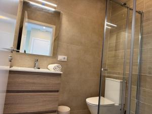 a bathroom with a toilet and a sink and a mirror at Besso Somhome in Peñíscola +31 photos