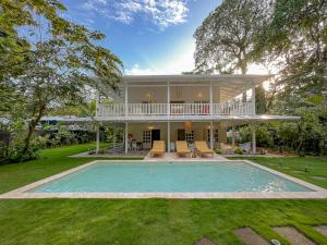 an exterior view of a house with a swimming pool at Casa Agog - Retreat Spacepoolsteps To Beach in Puerto Viejo