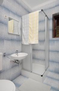 a bathroom with a shower and a sink at Apartments by the sea Klenovica, Novi Vinodolski - 5581 in Klenovica