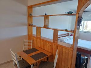 a small dining room with a table and a bed at Apartments by the sea Klenovica, Novi Vinodolski - 5581 in Klenovica +28 photos
