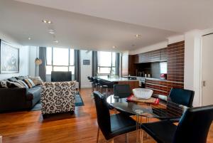 a living room with a couch and a table at Large Executive Inner City Apartment in Wellington