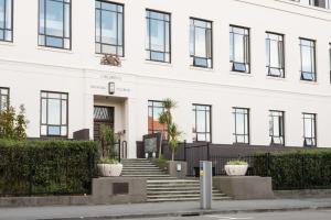a white building with stairs in front of it at Large Executive Inner City Apartment in Wellington