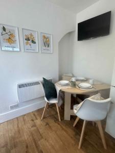 a dining room with a table and two chairs at Botanica convenient centre Stay free parking in Swindon