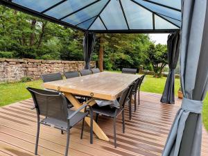 a wooden table and chairs on a wooden deck at Chambre Double avec Petit Déjeuner dans Bâtisse Historique - FR-1-589-717 in Moyenmoutier +11 photos