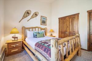a bedroom with a wooden bed and a wooden cabinet at Main Street Junction 11 condo in Breckenridge