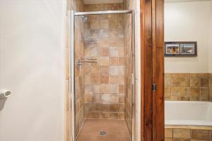 a bathroom with a shower with a tub at Main Street Junction 11 condo in Breckenridge