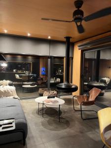 a living room with couches and chairs and a fireplace at Casa Mara Sierra 2 in Nueva Carrara