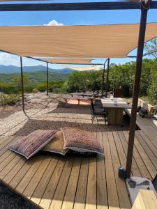 a wooden deck with a table and an umbrella at Casa Mara Sierra 2 in Nueva Carrara