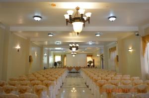 a banquet hall with rows of tables and chairs at Royal Ruiz in Ibarra