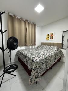 a bedroom with a bed with a blanket on it at Condominio HOME DUPLEX SERRA NEGRA in Bezerros +5 photos