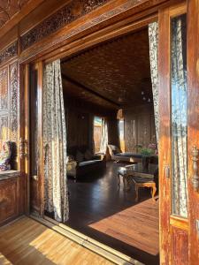 a living room with a large glass door in a house at BAKTOO palace PREMIUM HOUSEBOAT in Srinagar