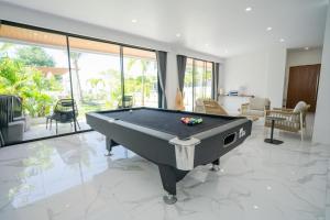 a living room with a pool table on a marble floor at Gandum Uluwatu Luxury Boutique Stay - Gandum Villa Complex in Uluwatu