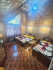 a room with two beds and a ceiling at BAKTOO palace PREMIUM HOUSEBOAT in Srinagar