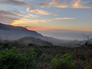 a view of a misty valley at sunset at Charming Retreat in Fontanales with Pool in Moya