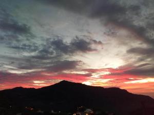 a sunset with a mountain in the background at Charming Retreat in Fontanales with Pool in Moya