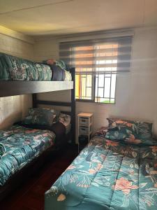 a bedroom with two bunk beds and a window at Casa Hostal Nora, Rauquén Curicó in Curicó
