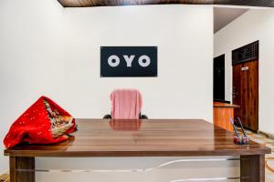 a table with a red bag sitting on top of it at SPOT ON Hotel Shyam & Restaurant in Prayagraj