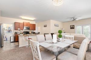 a dining room and kitchen with a table and chairs at 5BR Oasis with 3 Spa-Like Baths in Riverdale