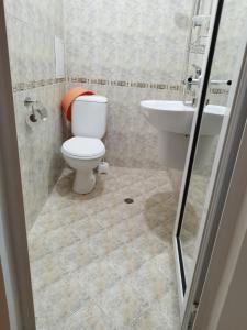 a bathroom with a toilet and a sink at стаи за гости Левтерови in Chernomorets