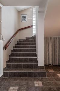a set of stairs in a building with a picture on the wall at Gylle Luxe & Retreat in Borlänge +1 photo